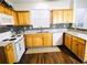 Updated kitchen with granite counters, wood cabinets, white appliances, and stylish backsplash at 1715 Crestwell Ln, Grayson, GA 30017