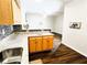 Modern kitchen featuring granite countertops and a view into the dining area with hardwood floors at 1715 Crestwell Ln, Grayson, GA 30017