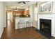 Open-concept living space with a cozy fireplace, modern breakfast bar, and hardwood floors at 1715 Crestwell Ln, Grayson, GA 30017