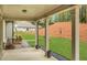 Covered back porch with stone walkway and view of manicured lawn with landscaped hillside at 174 Vandiver Ct, Acworth, GA 30101