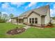 Exterior view of the home showcasing the manicured lawn and backyard with stone walkway at 174 Vandiver Ct, Acworth, GA 30101
