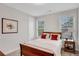 Bedroom with white walls, carpet, and a full sized wooden bed with red pillows at 174 Vandiver Ct, Acworth, GA 30101