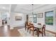 Dining area featuring hardwood floors, coffered ceilings, and abundant natural light at 174 Vandiver Ct, Acworth, GA 30101