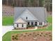 Charming home featuring a well-manicured lawn, brick accents and a welcoming front porch at 174 Vandiver Ct, Acworth, GA 30101