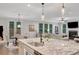 Bright kitchen with granite countertops, stainless steel sink, and an open floor plan that flows into living and dining areas at 174 Vandiver Ct, Acworth, GA 30101