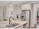 View of kitchen island with stainless steel appliances, pendant lighting, and breakfast bar at 174 Vandiver Ct, Acworth, GA 30101