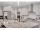 Modern kitchen showcasing stainless steel appliances, stone countertops, and ample cabinet space at 174 Vandiver Ct, Acworth, GA 30101