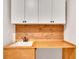 Laundry area with upper cabinets, a wooden countertop, and a utility sink for an efficient and organized laundry space at 174 Vandiver Ct, Acworth, GA 30101