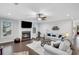A living room showcasing a cozy fireplace, large windows, hardwood flooring, and a comfortable sofa with stylish pillows at 174 Vandiver Ct, Acworth, GA 30101