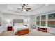 Bright main bedroom features tray ceilings, large windows, neutral paint, and an upholstered headboard at 174 Vandiver Ct, Acworth, GA 30101