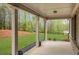 Covered back porch with a view of the green lawn at 174 Vandiver Ct, Acworth, GA 30101