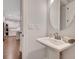 Modern powder room featuring a pedestal sink, stylish mirror, and sleek fixtures, adding a touch of elegance to the home's interior at 174 Vandiver Ct, Acworth, GA 30101