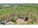 An aerial view of homes on lush lots nestled in a wooded area of mature trees at 205 Northampton Ct, Canton, GA 30115