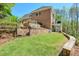 Large, well-maintained backyard with a stone wall, gate, fire pit and plenty of trees at 205 Northampton Ct, Canton, GA 30115