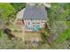 Aerial view of a lush backyard with patio, fire pit, and stone walkways at 205 Northampton Ct, Canton, GA 30115