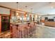 Home bar with custom lighting, plenty of seating, and access to an adjacent living area at 205 Northampton Ct, Canton, GA 30115