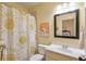 Bathroom with floral shower curtain, sink with white vanity and large mirror at 205 Northampton Ct, Canton, GA 30115