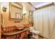Bathroom featuring a unique glass bowl sink, decorative mirror, and warm lighting at 205 Northampton Ct, Canton, GA 30115