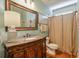 Charming bathroom featuring a classic vanity, decorative mirror and updated fixtures at 205 Northampton Ct, Canton, GA 30115