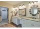 This bathroom features double sinks with granite countertops and decorative lighting at 205 Northampton Ct, Canton, GA 30115