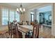 Bright dining room featuring a chandelier, large windows, and an open view into the living room at 205 Northampton Ct, Canton, GA 30115