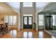 Grand foyer with gleaming hardwood floors, a double-door entry, and views into the dining and living rooms at 205 Northampton Ct, Canton, GA 30115