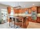 Gourmet kitchen features custom cabinets, granite counters, stainless appliances, and center island with seating at 205 Northampton Ct, Canton, GA 30115