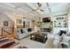 Open living room with coffered ceilings, built-in shelves, stone fireplace, and large windows overlooking the yard at 205 Northampton Ct, Canton, GA 30115