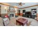Comfortable living room featuring a stone fireplace, built-in bookcases, and a large coffee table at 205 Northampton Ct, Canton, GA 30115