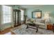 Comfortable living room featuring a plush sofa, stylish decor, and a large window for ample natural light at 205 Northampton Ct, Canton, GA 30115