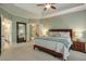 Large main bedroom featuring a tray ceiling, access to ensuite bathroom, and a cozy sitting area at 205 Northampton Ct, Canton, GA 30115