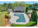 A community pool with a covered structure, privacy fence, and mature landscaping at 205 Northampton Ct, Canton, GA 30115
