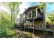 Home exterior featuring a multi-level back deck surrounded by lush greenery at 1207 Promontory Path, Marietta, GA 30062
