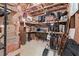 Unfinished basement space with exposed wooden beams, shelving and space for storage at 1207 Promontory Path, Marietta, GA 30062