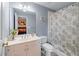 Bathroom with a vanity, white cabinets, large mirror, and shower with patterned curtain at 1207 Promontory Path, Marietta, GA 30062