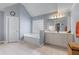 Bathroom featuring tile floors, a soaking tub, and a white vanity with cabinet storage at 1207 Promontory Path, Marietta, GA 30062