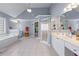 Bright bathroom boasts dual sinks, a tub, a separate shower and plenty of counter space at 1207 Promontory Path, Marietta, GA 30062