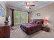 Cozy bedroom featuring a ceiling fan and a large window with natural light at 1207 Promontory Path, Marietta, GA 30062