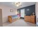 Comfortable bedroom featuring neutral carpet and a single bed with built-in drawers at 1207 Promontory Path, Marietta, GA 30062