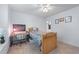 Well lit bedroom featuring neutral carpet, a ceiling fan, and a desk area at 1207 Promontory Path, Marietta, GA 30062