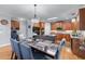 Dining area featuring a hardwood floor, a dining table, chandelier, and a view into the kitchen at 1207 Promontory Path, Marietta, GA 30062
