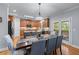 Bright dining area featuring hardwood floors and a modern chandelier above a wooden table with seating for six at 1207 Promontory Path, Marietta, GA 30062