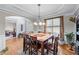 Elegant dining room with hardwood floors, chandelier, and easy access to the living room at 1207 Promontory Path, Marietta, GA 30062