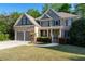 Beautiful two-story home with manicured lawn, brick accents, and a two-car garage at 1207 Promontory Path, Marietta, GA 30062