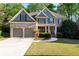 Charming two-story home with manicured lawn, brick accents, and a two-car garage at 1207 Promontory Path, Marietta, GA 30062