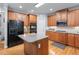 Well-lit kitchen featuring wooden cabinets, an island and stainless steel appliances on hardwood floors at 1207 Promontory Path, Marietta, GA 30062