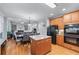 Kitchen opens to dining and living areas, featuring hardwood floors, stainless appliances, and a center island at 1207 Promontory Path, Marietta, GA 30062