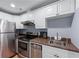 Finished basement with a kitchen area, complete with stainless steel appliances at 1207 Promontory Path, Marietta, GA 30062