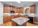 Bright kitchen featuring wooden cabinets, a central island, tile backsplash, and stainless steel appliances at 1207 Promontory Path, Marietta, GA 30062