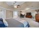 Large main bedroom boasts a ceiling fan, sitting area, and access to ensuite bathroom at 1207 Promontory Path, Marietta, GA 30062